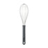 Metal whisk with black handle on a white background